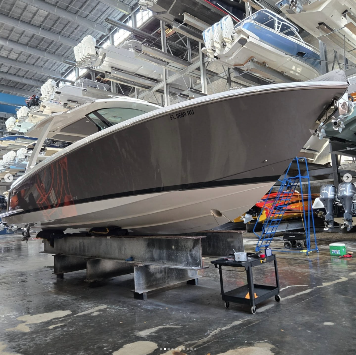 Detailed boat in dry-storage facility after exterior polish and gloss restoration