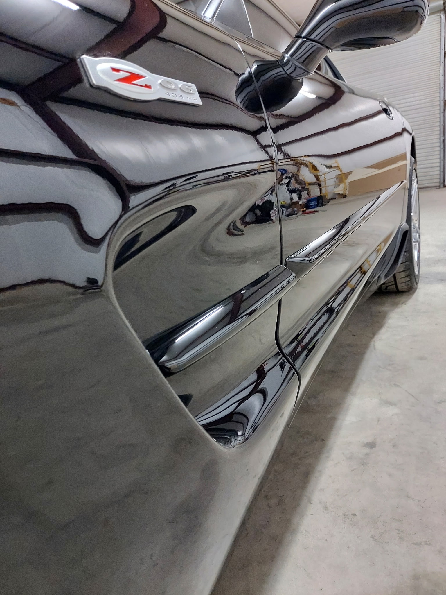 Deep gloss reflection on a black Chevrolet Corvette Z06 after paint polishing