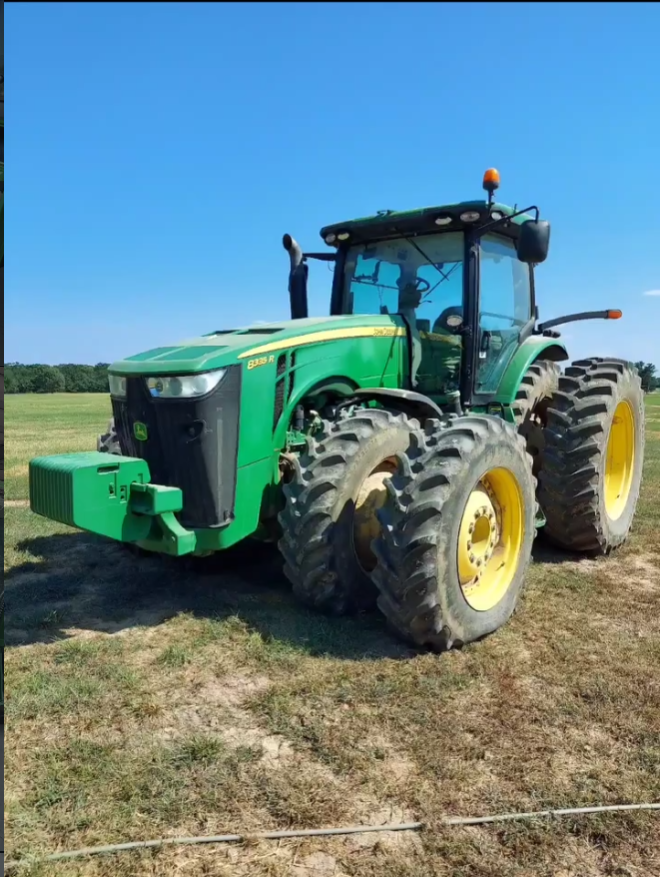 Green John Deere 8335R tractor after exterior detailing in the field