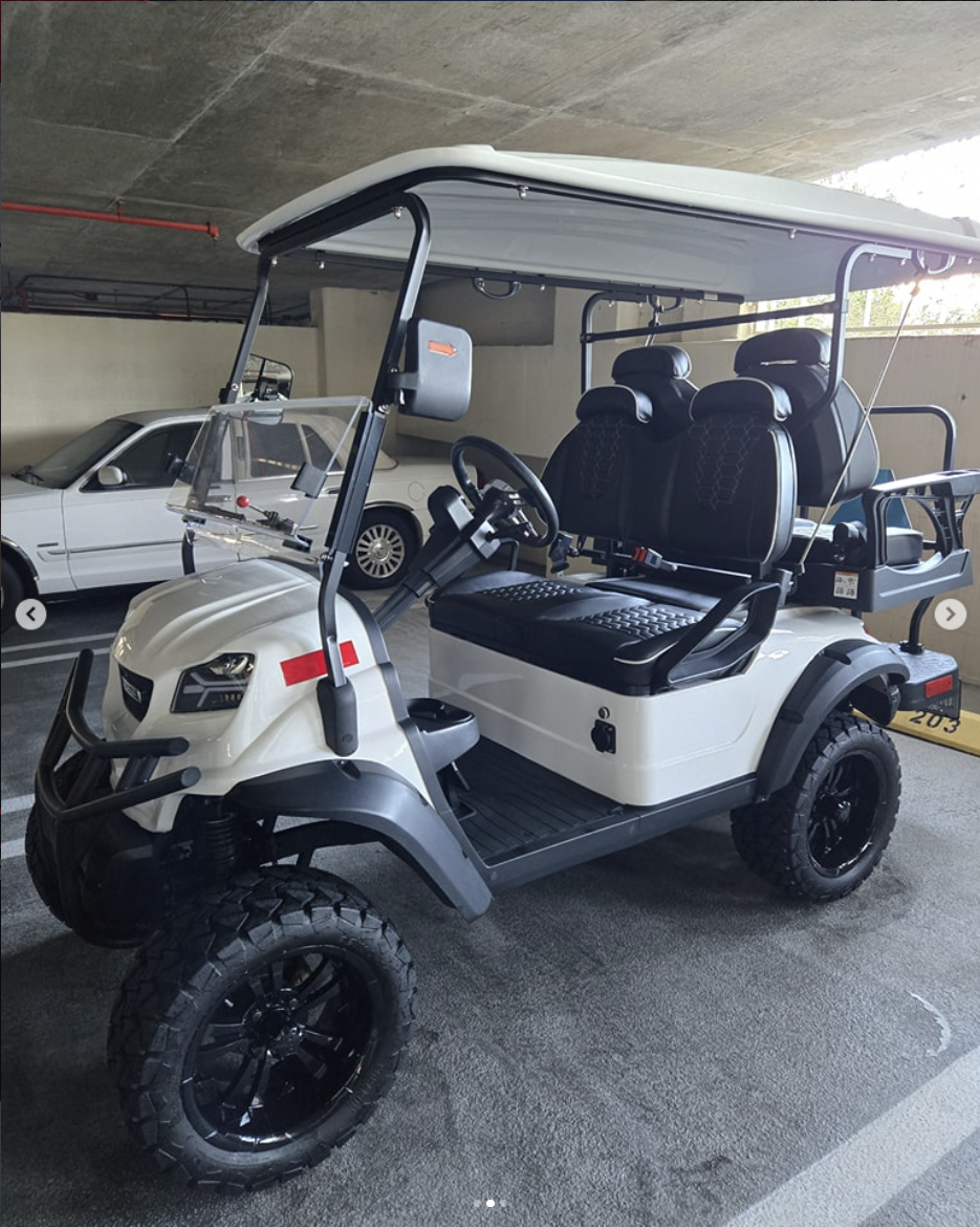 White lifted golf cart after professional exterior and interior detailing
